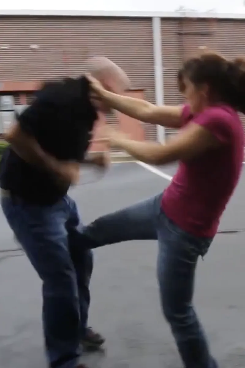 Adult Krav Pro class practicing movement and positioning with instructor guidance.