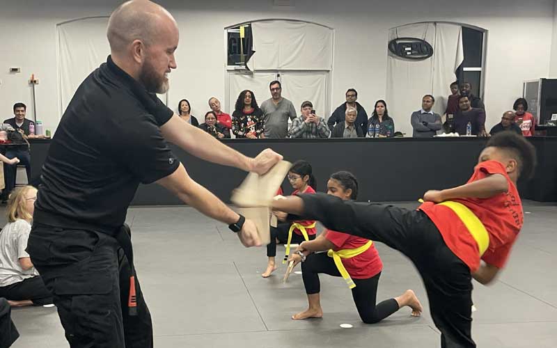 Child practicing kick drills at Krav Pro