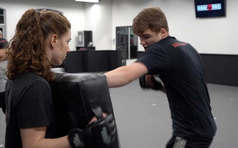 Instructor coaching a student at Krav Pro