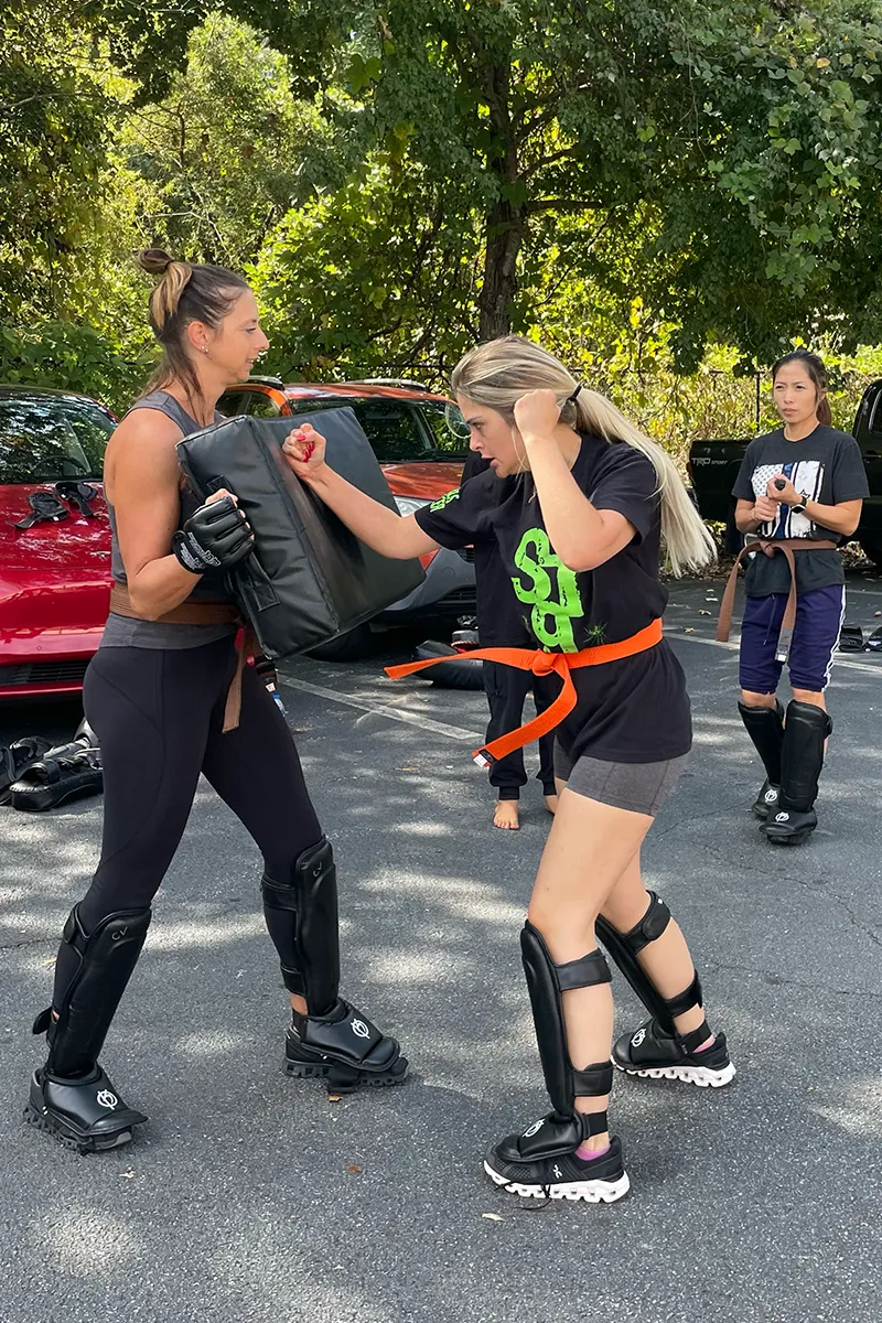 Adult Krav Pro students practicing controlled movement and distance during class.