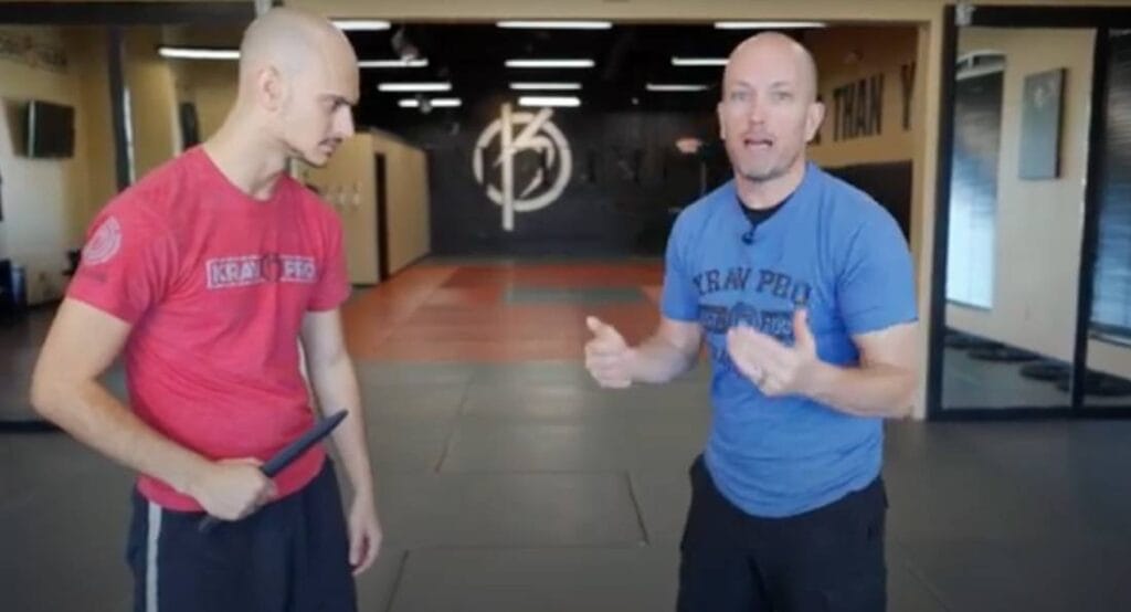 Martial arts instructor demonstrating a knife defense