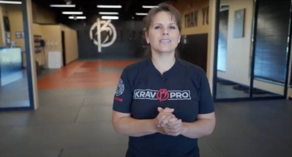 Self defense class instructor teaching a technique