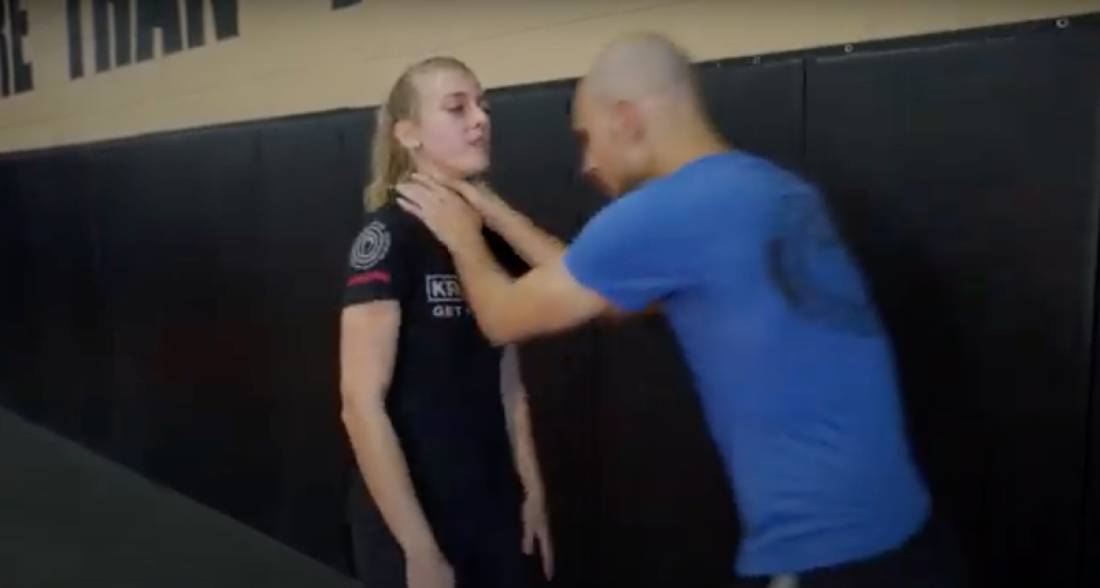 martial arts instructor teaching how to break a choke hold